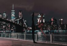 체육 18년차 경력 대표 직강 바레 지도자과정 woman in black sports bra and tights doing ballet position on sidewalk during nighttime