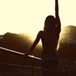 마이바레의 4번째 시그니처 프로그램 OPEN woman in white tank top and black shorts standing on balcony during sunset